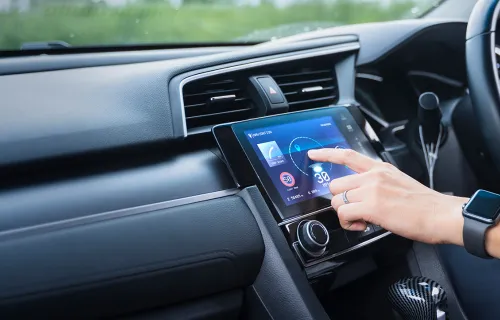 Driver using touch-screen infotainment system in car
