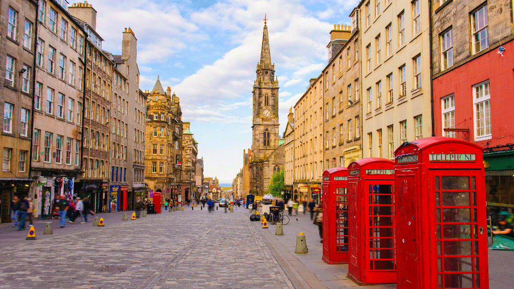 Cobbled city street with red phone boxes
