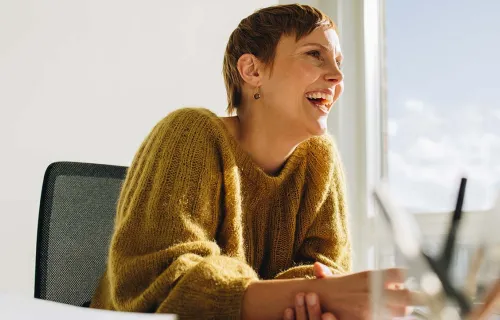 woman smiling looking at computer